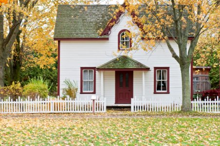 White And Red Wooden House With Fence photo