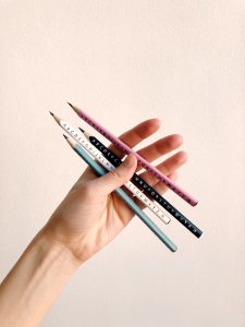 Photo Of Person Holding Assorted Pencils photo