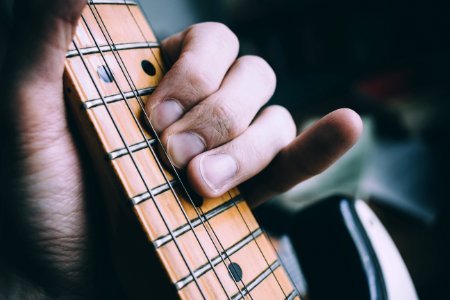 Photo Of Person Playing The Guitar photo
