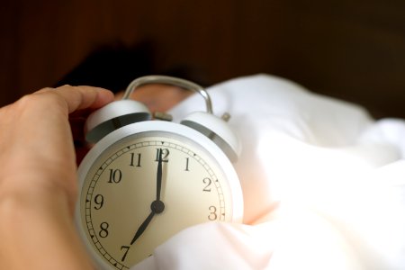 Photo Of Person Holding Alarm Clock photo