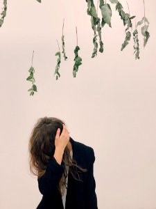 Woman Wearing Black Blazer Beside White Wall photo