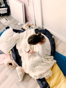 Woman Wearing Sweatshirt Holding Cream Jar