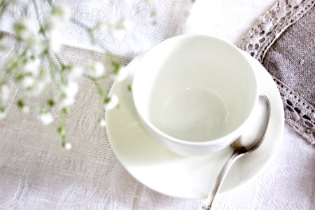 White Ceramic Tea Cup With Saucer And Spoon photo