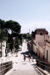 Man And Woman Walking On Gray Road photo