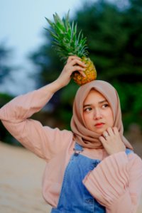 Woman Holding Pineapple On Her Head photo