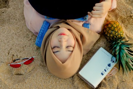 Woman Lying On Sand Beside Sunglasses photo