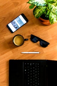 Black Sunglasses On Brown Wooden Surface photo