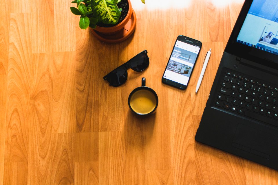 Black Laptop On Brown Table