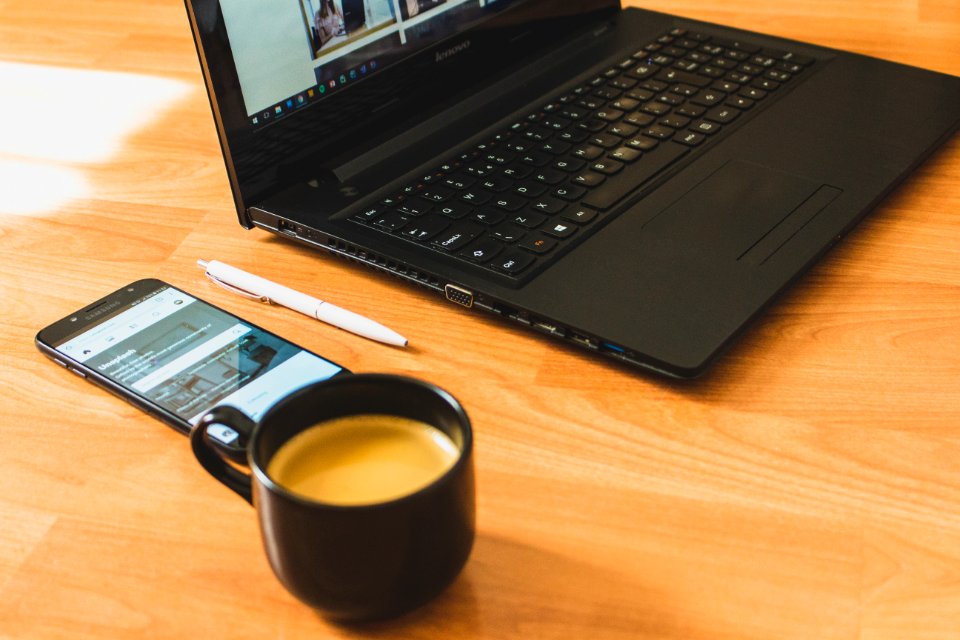 Black Laptop Computer And Black Ceramic Tea Cup