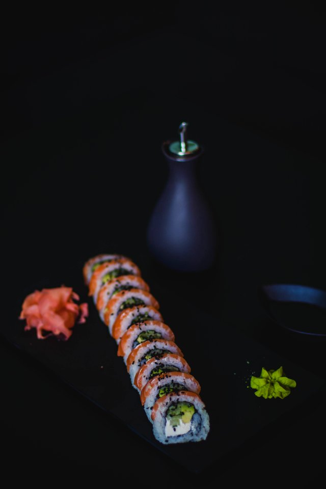Sushi And Oil Bottle On Top Of Table