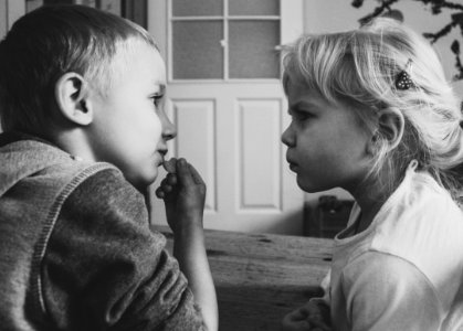 Grayscaled Photo Of Boy And Girl photo