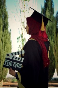 Woman Wearing Academic Dress While Holding Clipperboard photo