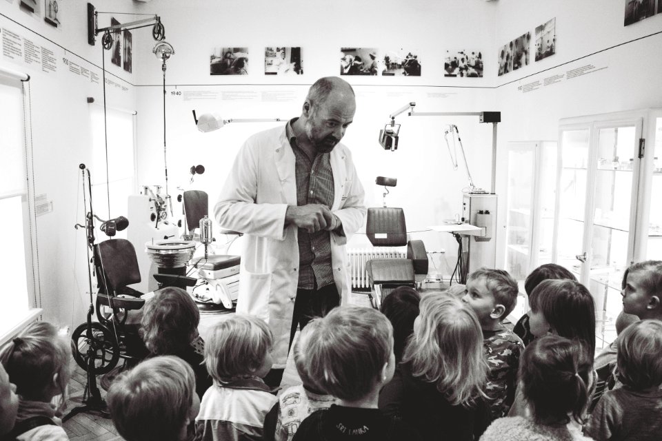 Grayscale Photo Of Man Lecturing Children
