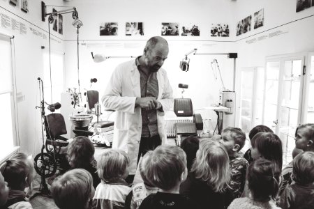 Grayscale Photo Of Man Lecturing Children