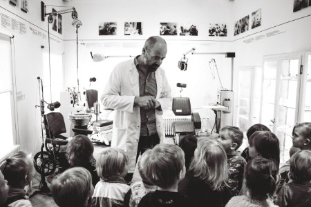 Grayscale Photo Of Man Lecturing Children photo