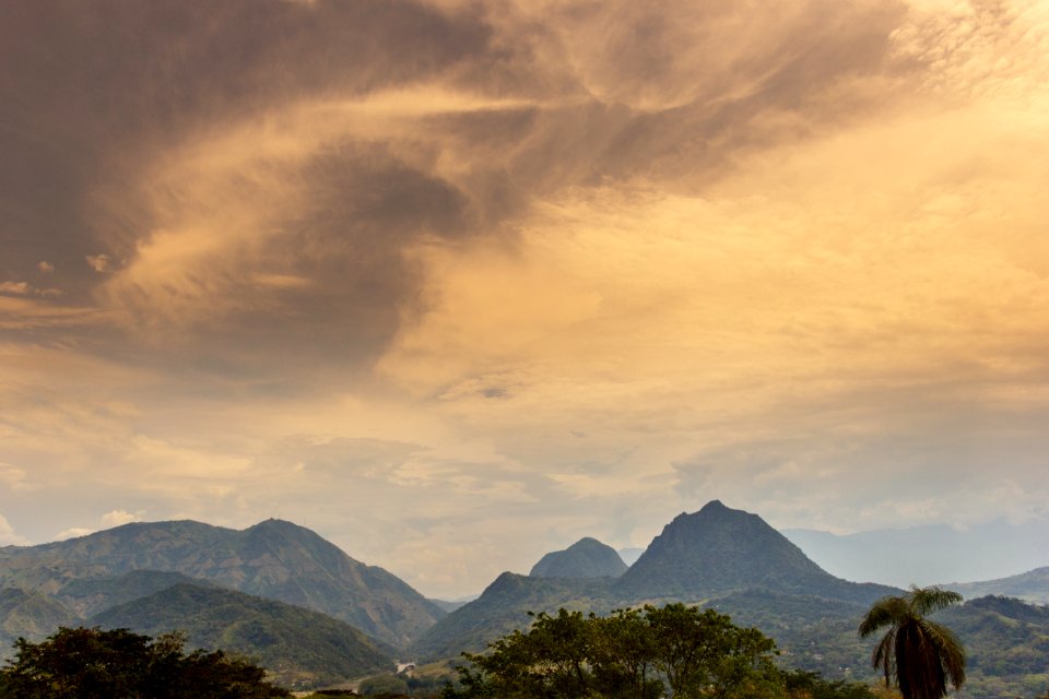 Scenic View Of Mountain Under Cloudy Sky