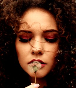 Close-Up Photo Of Woman Holding Dandelion Flower photo