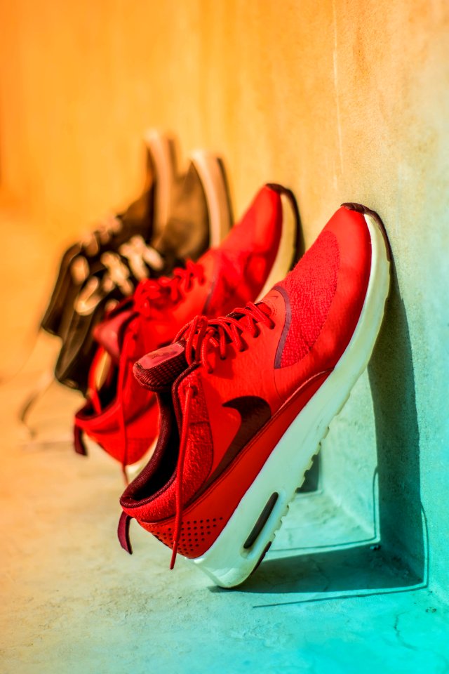 Focus Photography Of Pair Of Red Nike Running Shoes