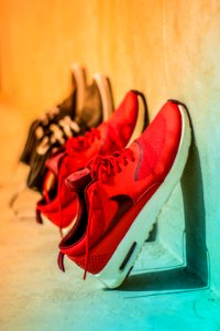 Focus Photography Of Pair Of Red Nike Running Shoes