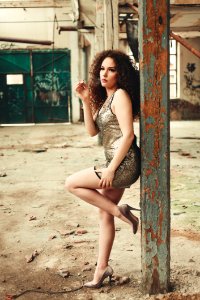 Photo Of Woman Smoking Cigarette While Leaning On Wooden Post photo