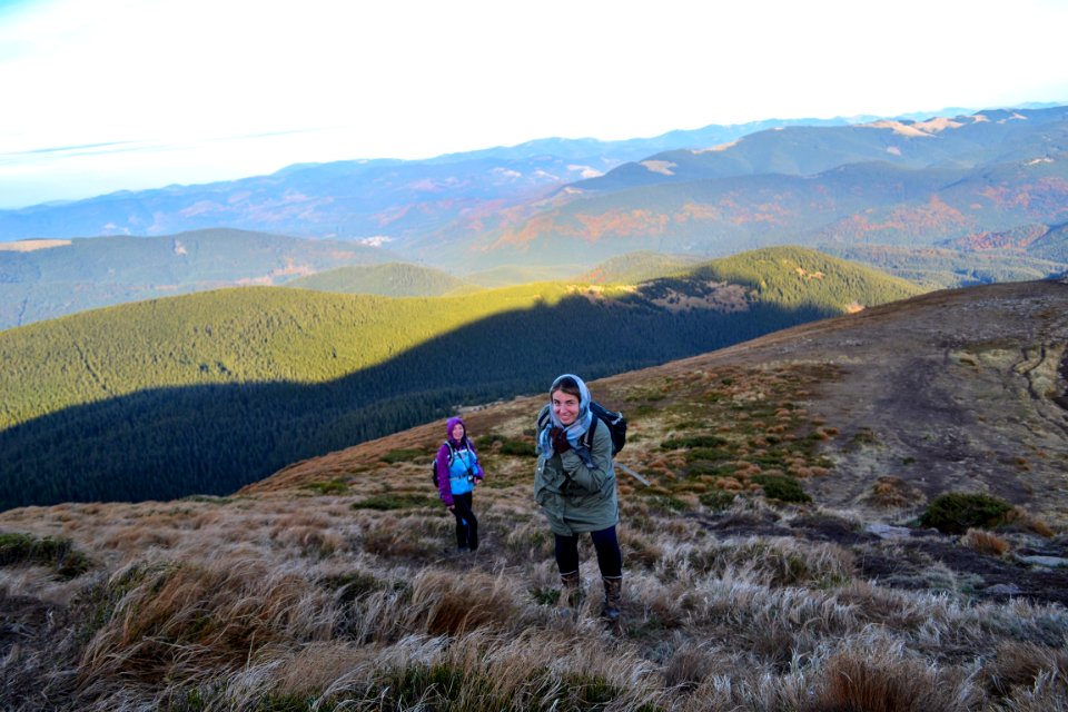 Two Women Trekking Up A Mountain