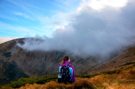 Photography Of Woman Wearing Jacket On Mountain Peak photo