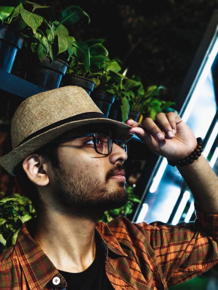 Man Wearing Brown And Gray Plaid Collared Shirt With Brown Fedora Hat And Black Framed Eyeglasses photo