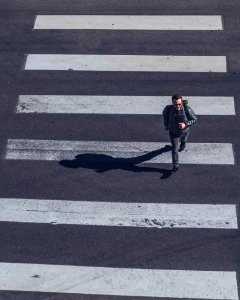 Man Crossing On Pedestrian Lane