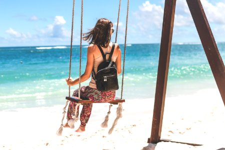 Woman Sitting On Seashore Swing photo