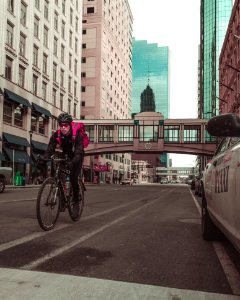 Photo Of Man Riding Bicycle On The Road photo