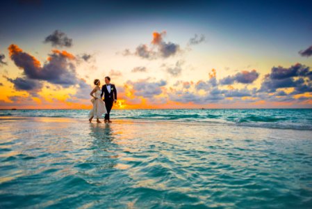 Man And Woman Walking Of Body Of Water photo