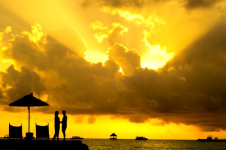 Silhouette Photo Of Man And Woman Beside Body Of Water During Sunset photo