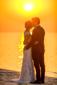 Man And Woman Kissing Under Sunset