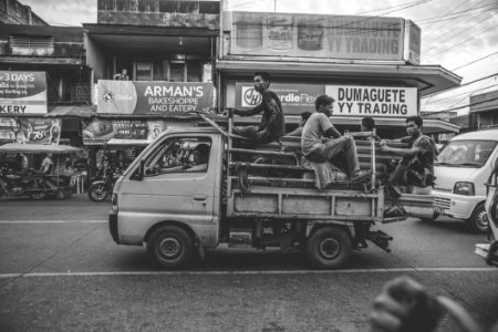 Grayscale Photo Of Men Riding On Kei Truck photo