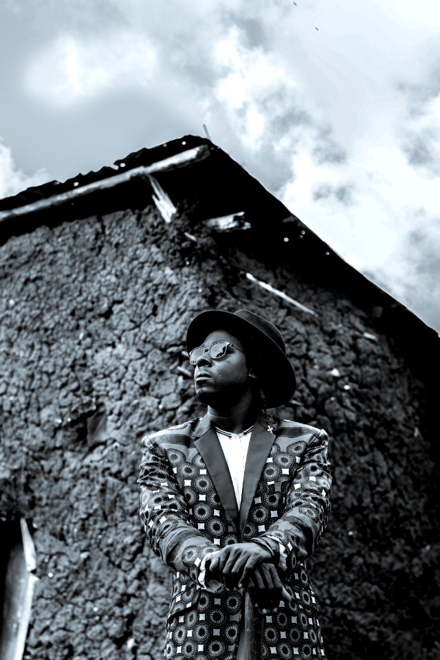 Man Wearing Hat And Suit Jacket In Grayscale Photography photo