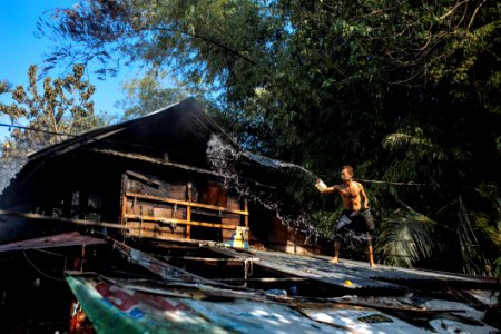 Man Throwing Water On Roof