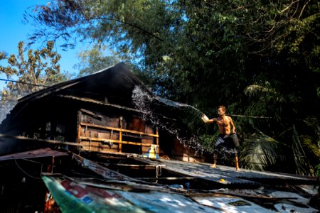 Man Throwing Water On Roof photo