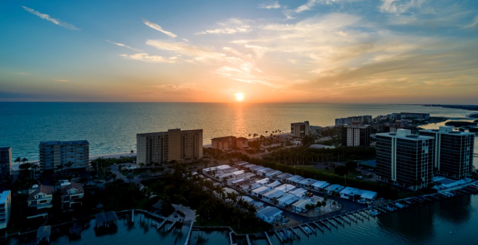 Skycraper Near Ocean Under Sunset photo