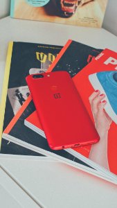 Red Oneplus Smartphone On Books