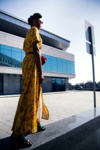 Woman In Yellow And Pink Floral Dress Standing photo