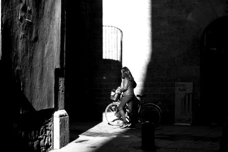 Grayscale Photo Of Woman With Her Bicycle photo