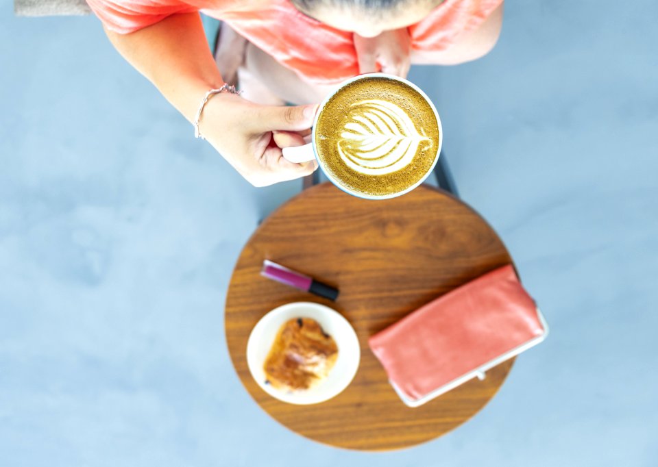 Top View Photography Of A Woman Holding Coffee Cup