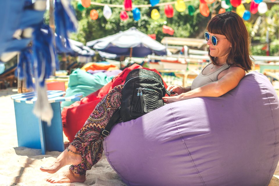 Woman Wearing Gray Tank Top Sitting On Purple Bean Bag