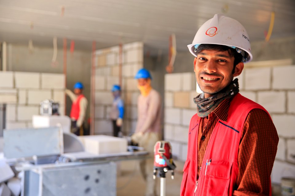Man Wearing Red Zip-up Vest And White Helmet Smiling