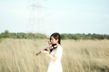 Woman Wearing White Dress Playing Violin photo