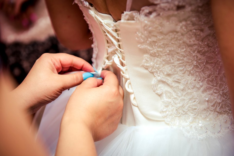Photo Of Woman Fixing The Wedding Gown