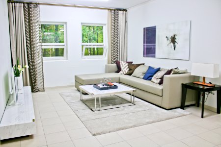 Gray Leather Sectional Sofa With White Coffee Table photo