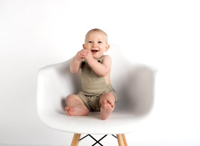 Baby Sitting On White Chair