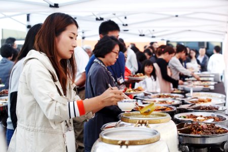 People In Front Of Food Containers