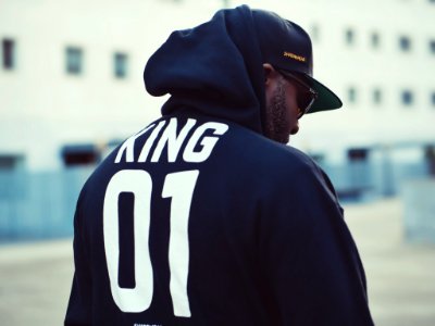 Man Wearing Black King 01-printed Hoodie And Flat Brim Cap photo